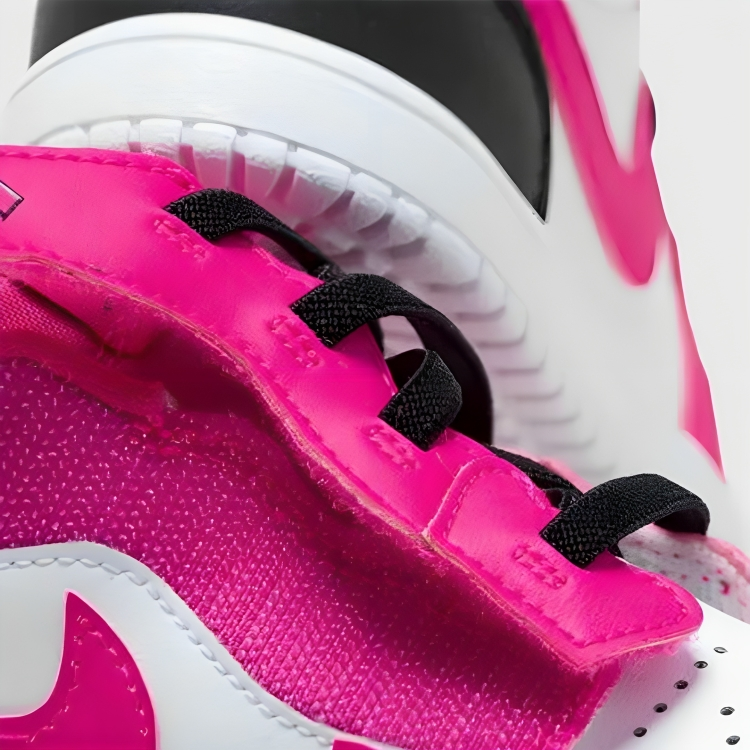 a close up of a pink and white tennis shoe
