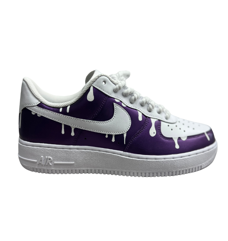 a purple and white shoe with white drip on it