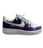 a purple and white shoe with white drip on it