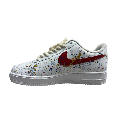 a white shoes with splatter paint on it