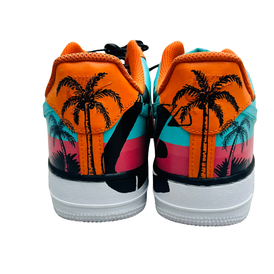a pair of shoes with palm trees painted on them
