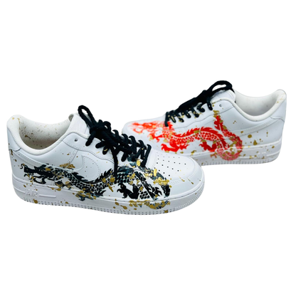 a pair of shoe with black and red snake on it