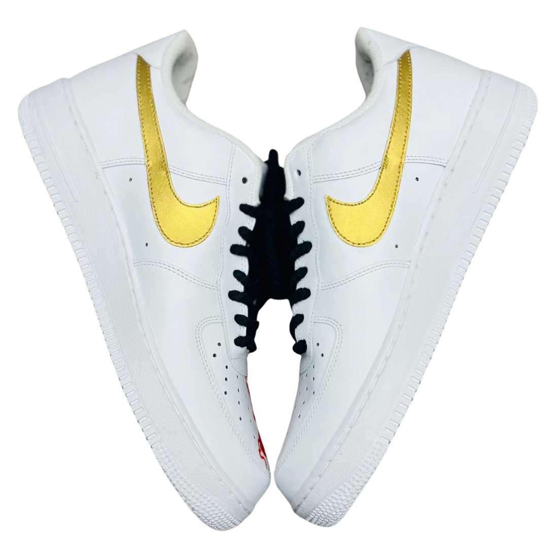a pair of white shoe with golden swoosh on it