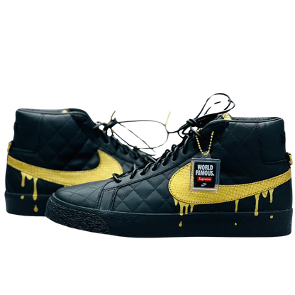 a pair of black shoes with yellow paint dripping on them