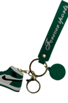 a green and white shoe keychain 