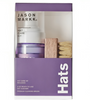 a purple box with a white label and a bottle of hair care kit