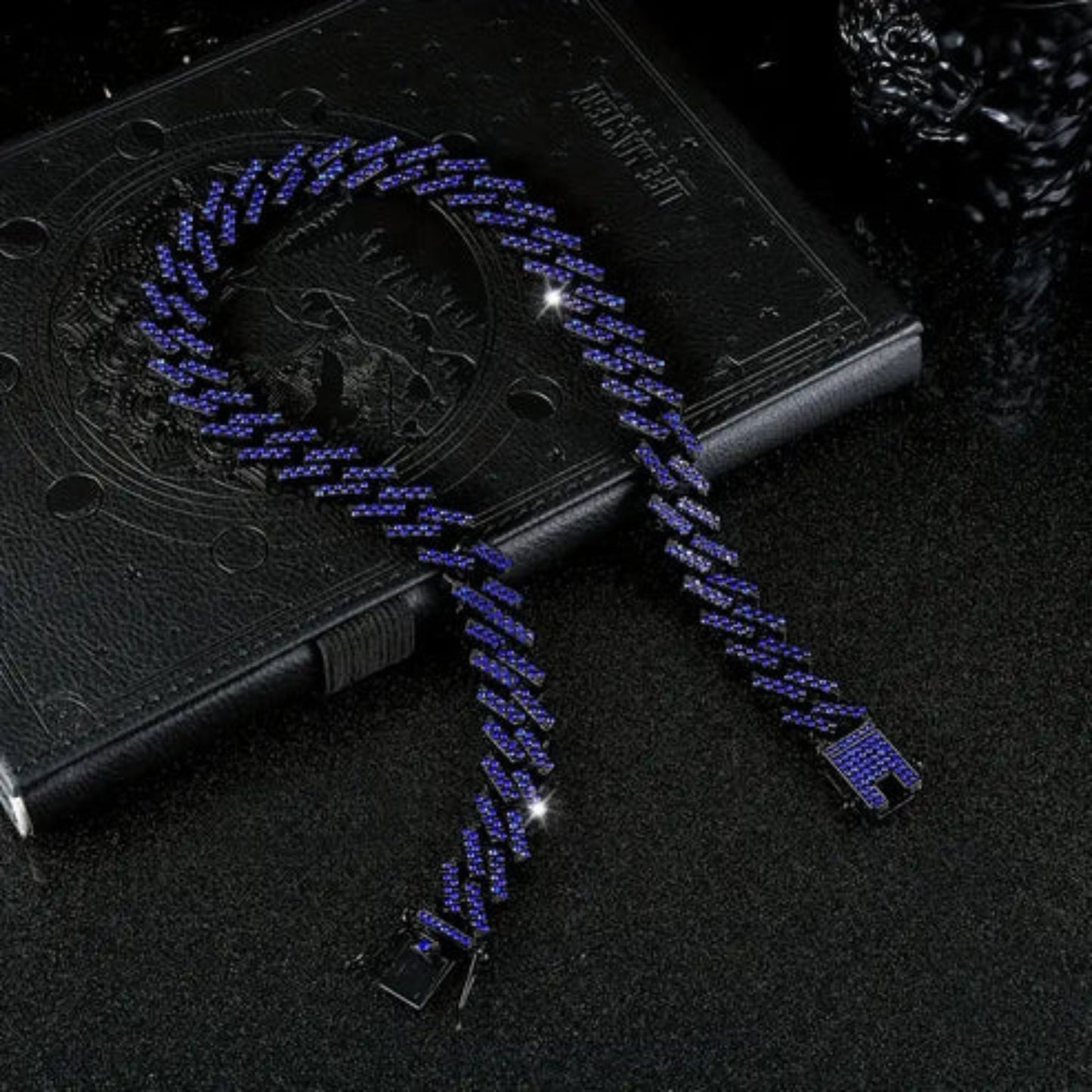 a blue necklace on a book