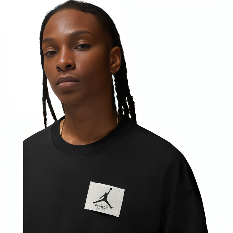 a person with dreadlocks wearing a black shirt