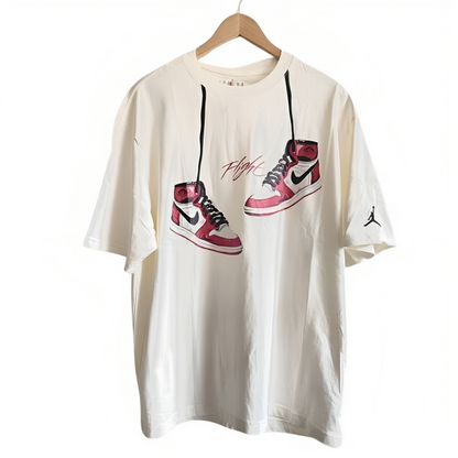 a white t-shirt with red shoes on it