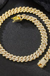 a gold necklace on black surface