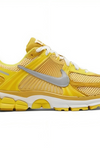 a yellow and white running shoe