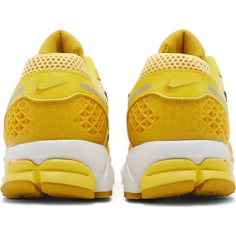 a close up of a pair of yellow sneakers